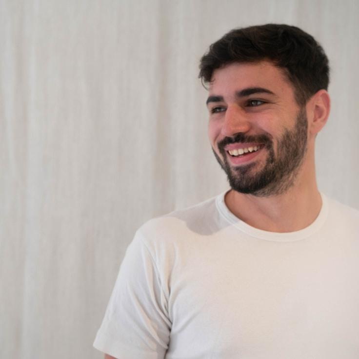 Kaveri Mehta, Lead Design Curator at BridgePaperGrove, reviewing corporate floral arrangements